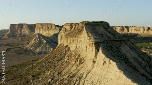 Aerial shot rotating around a cliff in a desert, in Bardenas Reales, Spain photo