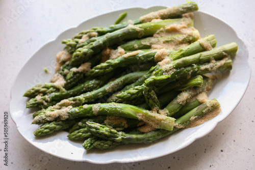Cooked green asparagus lying on a plate