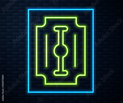 Glowing neon line Blade razor icon isolated on brick wall background. Vector