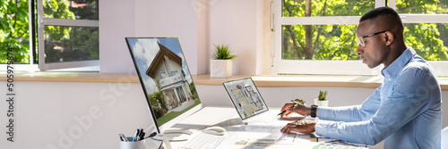 Real Estate Designer Working On Computer photo