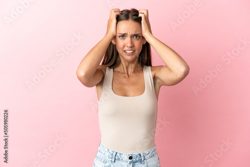 Young woman over isolated pink background doing nervous gesture © luismolinero