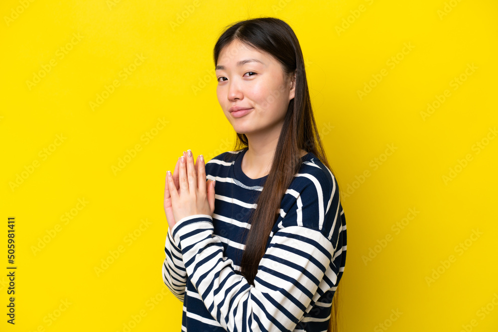 Young Chinese woman isolated on yellow background scheming something Young Chinese woman isolated on yellow background scheming something
