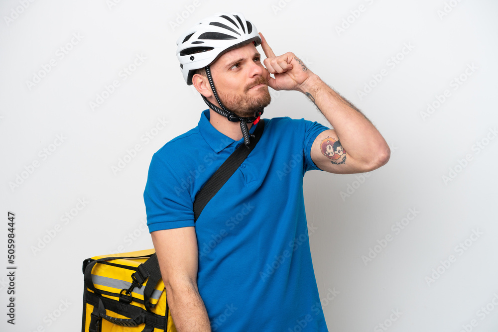 Young brazilian man with thermal backpack isolated on white background having doubts and with confuse face expression Young brazilian man with thermal backpack isolated on white background having doubts and with confuse face expression