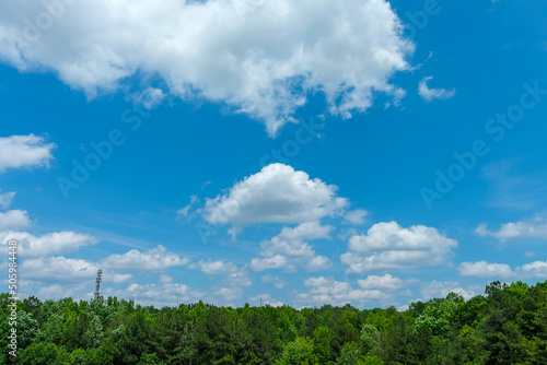 a gorgeous blue sky with powerful clouds with lush green trees at Lake Spivey Recreation Center in Jonesboro Georgia USA photo