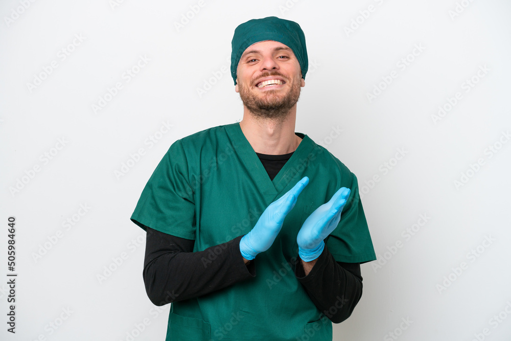 Surgeon Brazilian man in green uniform isolated on white background applauding after presentation in a conference Surgeon Brazilian man in green uniform isolated on white background applauding after presentation in a conference