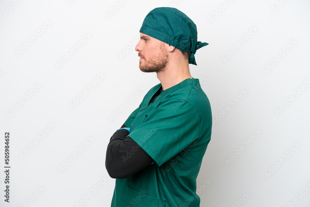 Surgeon Brazilian man in green uniform isolated on white background in lateral position Surgeon Brazilian man in green uniform isolated on white background in lateral position