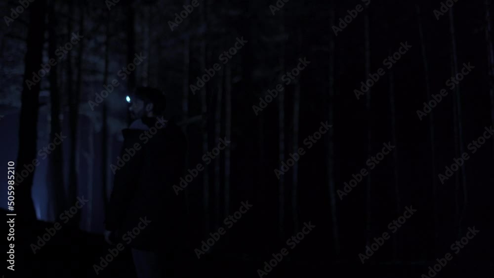 Man walking in the forest in the dark. Man walking in the forest in the dark. He's got a pickaxe. Man walking in the forest in the dark. Man walking in the forest in the dark. He's got a pickaxe.