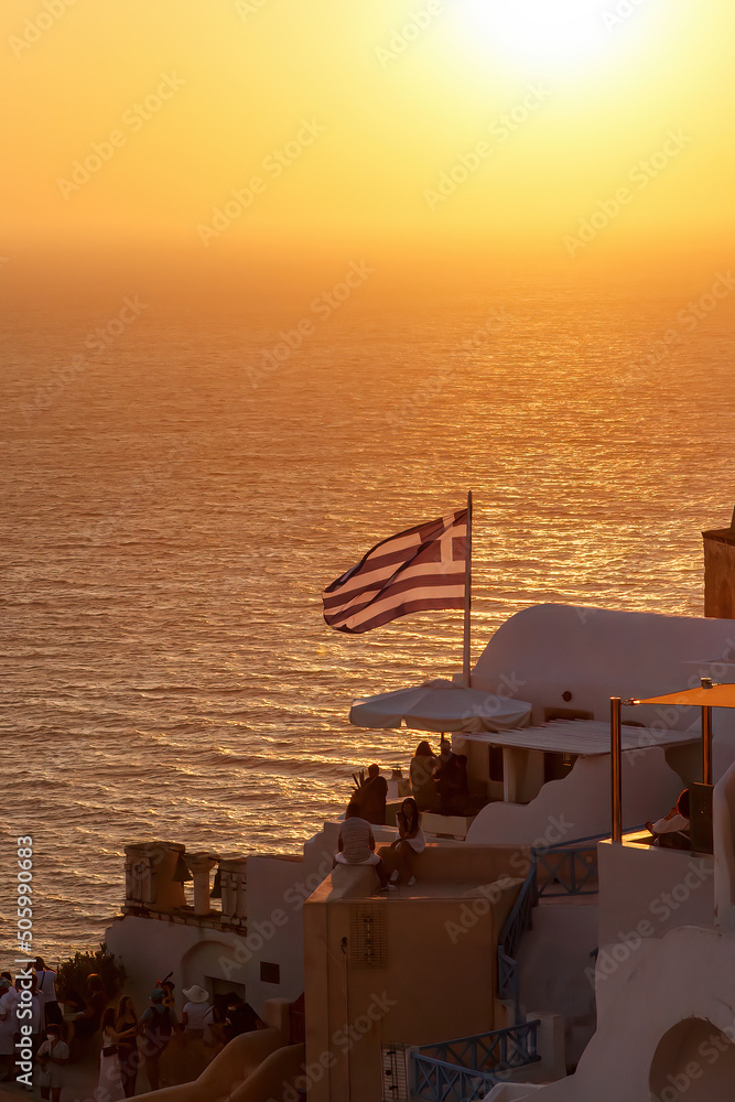 Fototapeta premium Greek flag near Aegean sea during sunset.