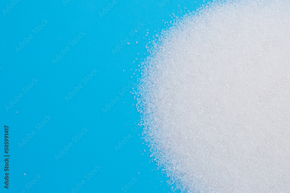 White sugar on blue background. White sugar on blue background.