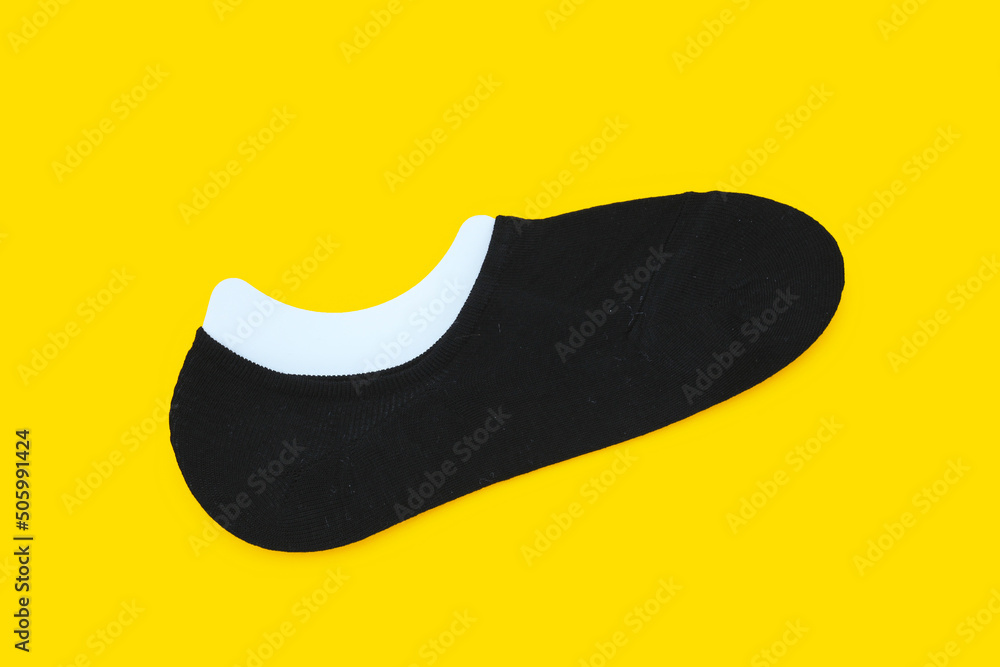 Black socks on yellow background. Black socks on yellow background.