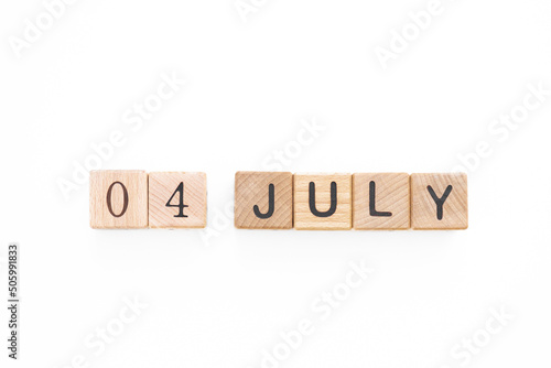 4 July. Independence Day. Calendar square cubes with shadows isolated on green summer background