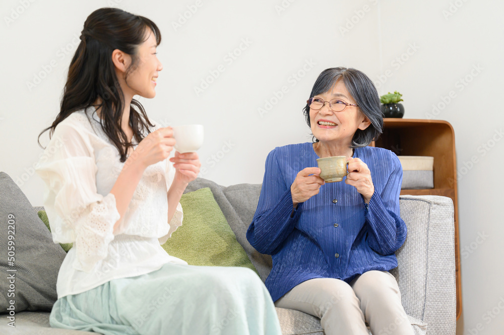And for the main visual! Elderly mother and daughter relaxing in the living room