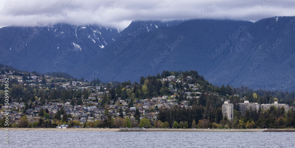 Residential Homes in a modern city with mountain landscape in background. North Vancouver, British Columbia, Canada.