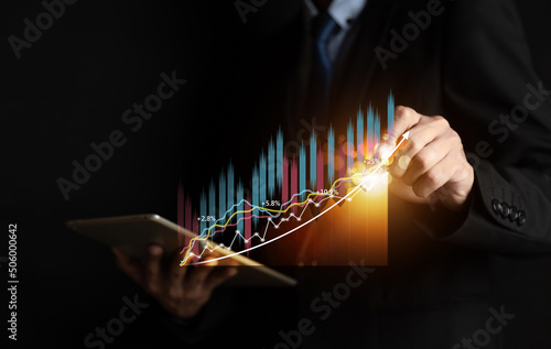 Businessman or trader is showing a growing virtual hologram stock, invest in trading. planning and strategy, Stock market, Business growth, progress or success concept.