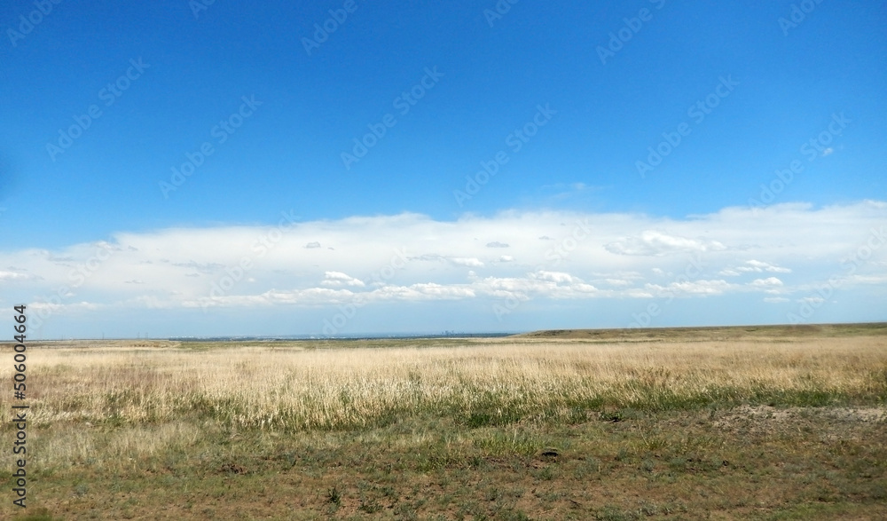 Colorado dry spring landscape with dry grasses and Denver in the far background Colorado dry spring landscape with dry grasses and Denver in the far background