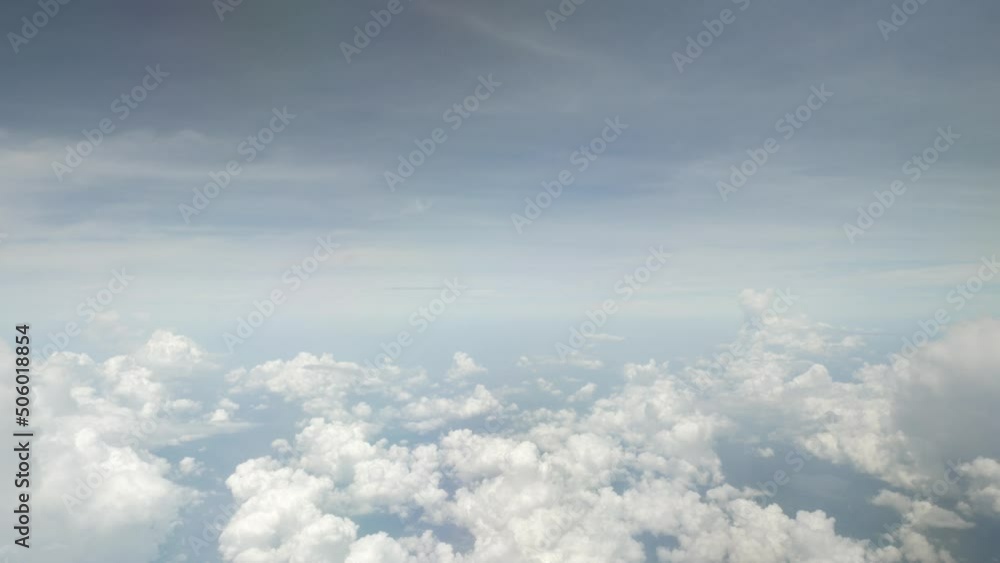 view of sky with white puffy cloud and sun light above sky.cloudscape in summer view of sky with white puffy cloud and sun light above sky.cloudscape in summer