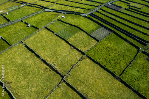 Green grass fields between stone fences of walls. Aerial top down view on meadow. Irish landscape. Aran Island, county Galway, Ireland. Popular and famous travel area. photo