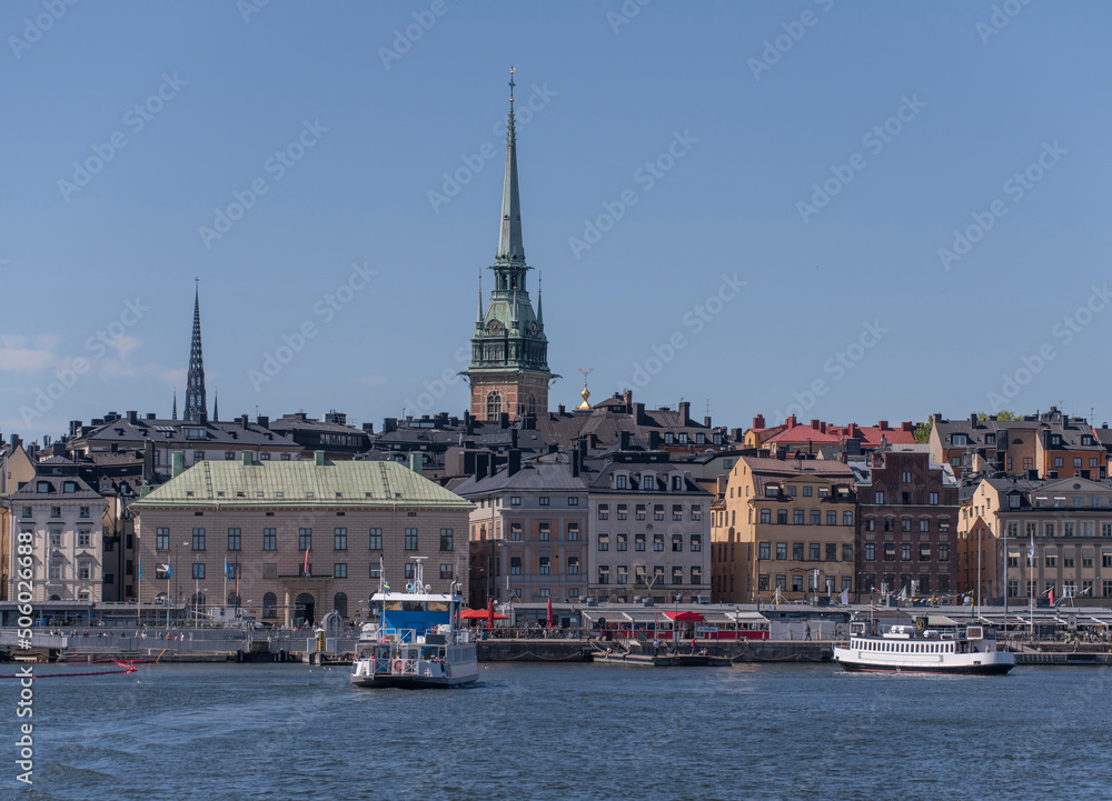 Ferries at a pier in the old town Gamla Stan a sunny day in Stockholm