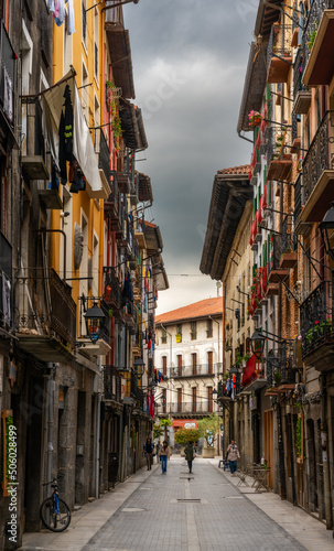 narrow street with colorful buildings in the historic city center of Tolosa © makasana photo