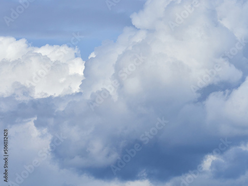 Cumulus clouds. White clouds on the blue sky close-up. © Sergey