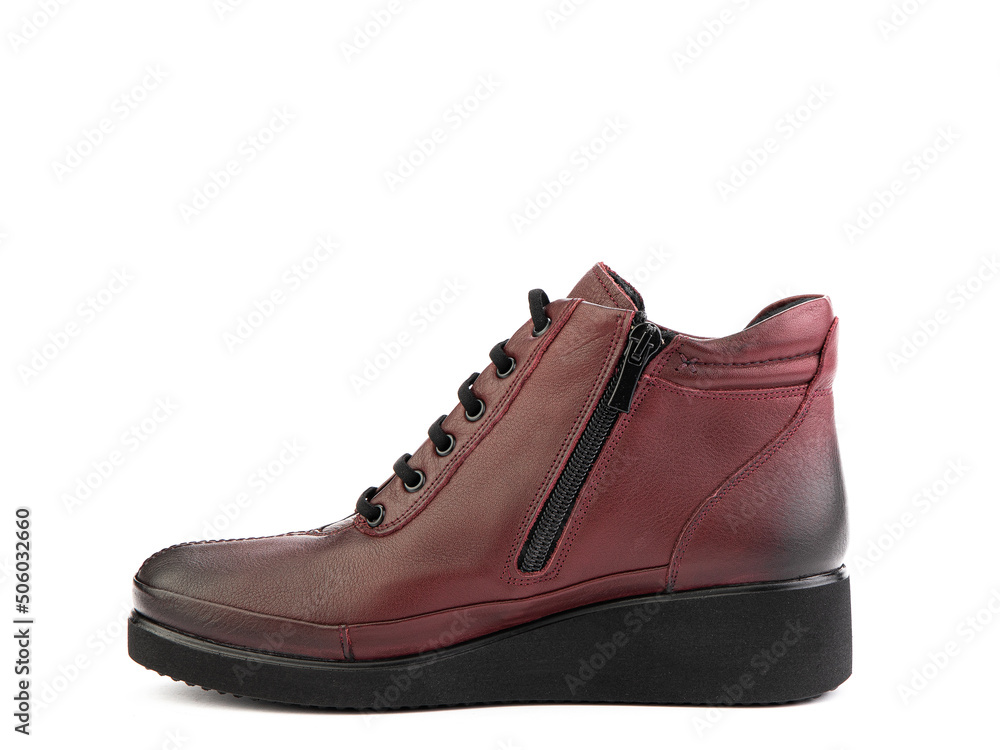 Women's autumn red leather jodhpur boots with black sole isolated on white background. Left side view. Fashion shoes. Photoshoot for shoe shop concept Women's autumn red leather jodhpur boots with black sole isolated on white background. Left side view. Fashion shoes. Photoshoot for shoe shop concept