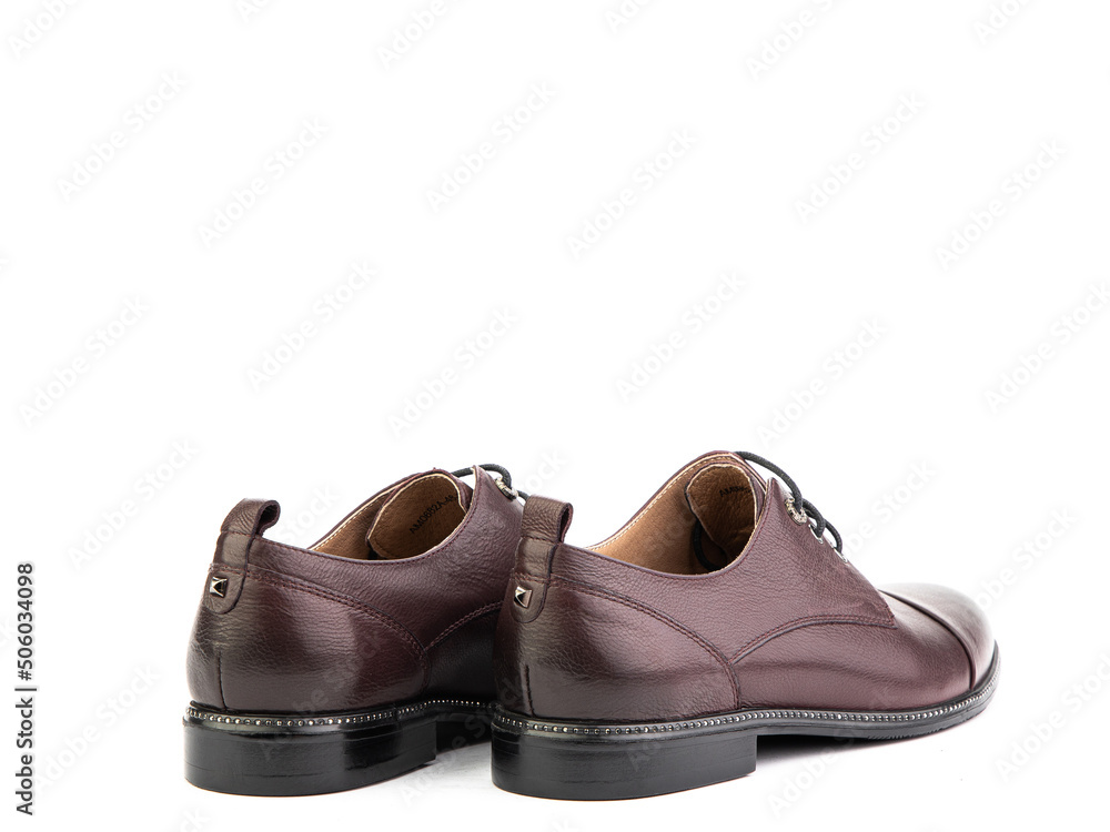 A classic leather elegant men's shoes isolated white background. Groom's stylish brown shoes. Isolated object close up on white background. A classic leather elegant men's shoes isolated white background. Groom's stylish brown shoes. Isolated object close up on white background.