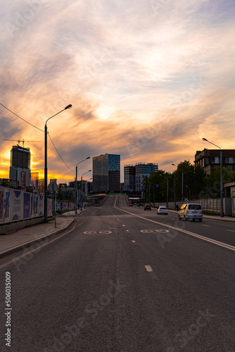 Sunset on the road and street with the architecture of new residential buildings in Moscow