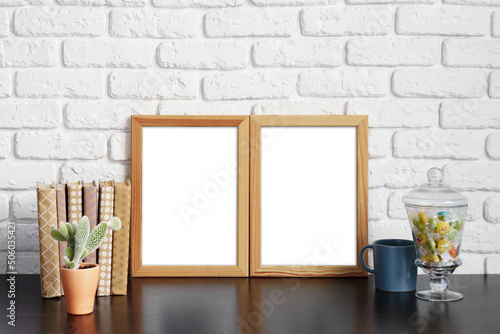 Books with picture frame on wooden table © fotofabrika
