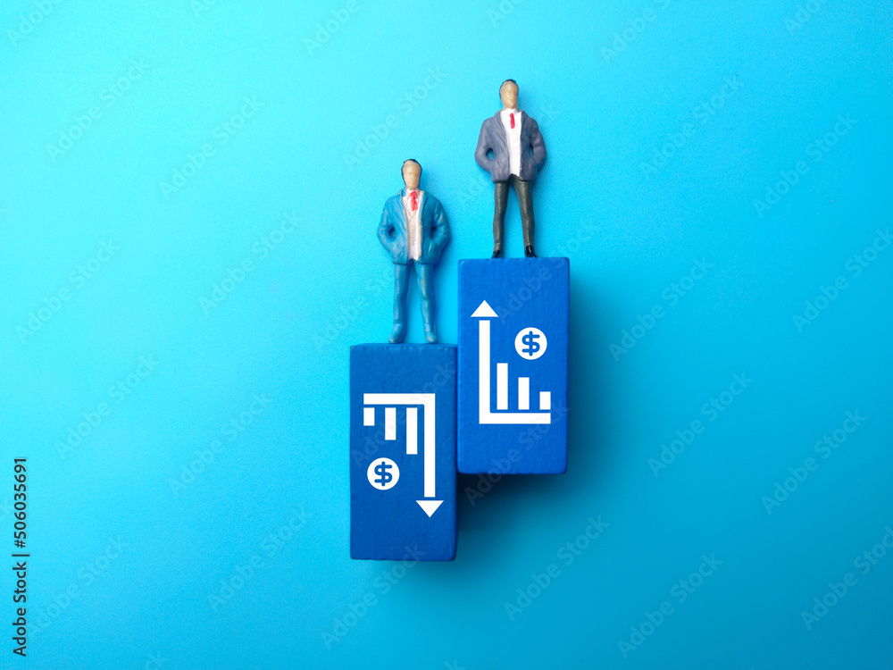 Miniature people and wooden block with business graf icon. The concept of business decline and increase Miniature people and wooden block with business graf icon. The concept of business decline and increase
