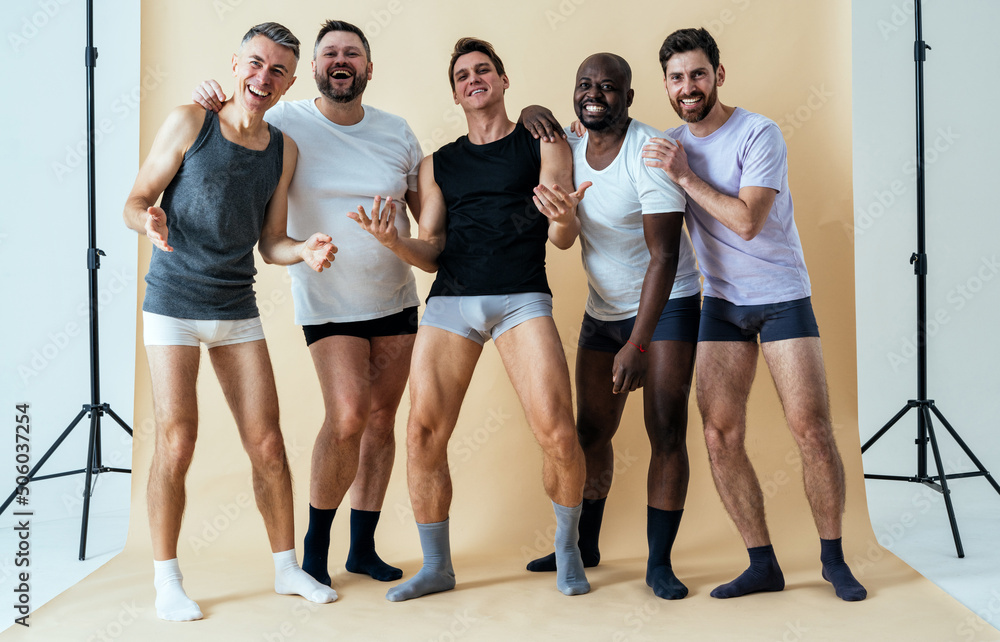 Fototapeta premium group of multiethnic men posing for a male edition body positive beauty set. guys with different age, and body wearing boxers underwear