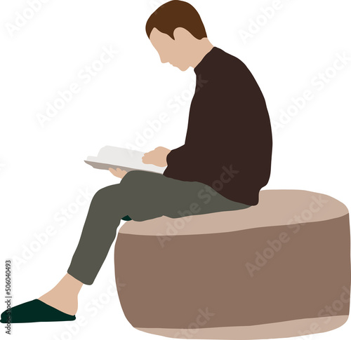 A guy in a sweater sits on a pouffe and reads a book
