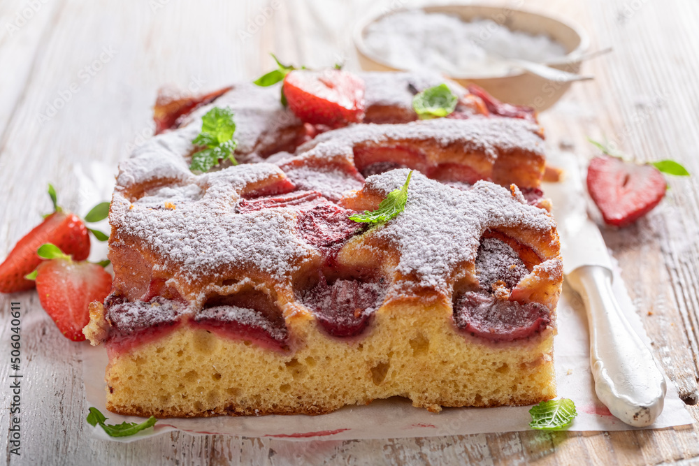 Hot and delicious strawberry cake with fresh fruits and sugar.