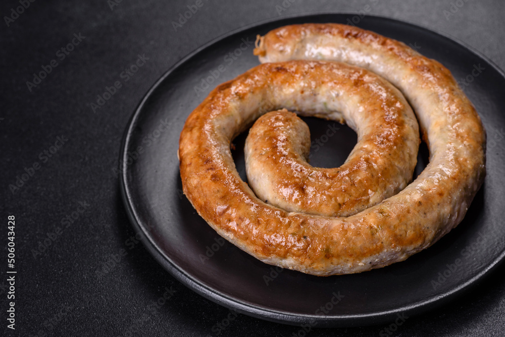 Baked homemade sausage with spices and herbs, close up Baked homemade sausage with spices and herbs, close up