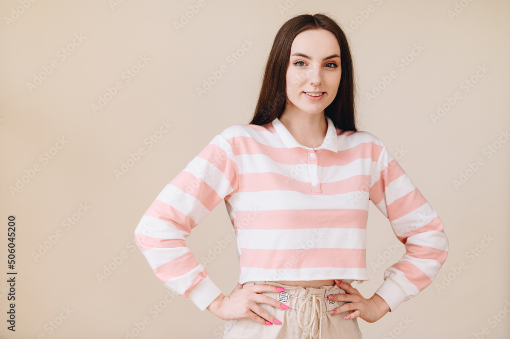 portrait of a girl with brown hair, smiling stupidly, arms at her sides. Light photo processing portrait of a girl with brown hair, smiling stupidly, arms at her sides. Light photo processing