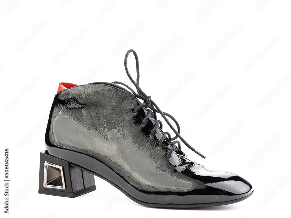 Women's autumn ankle black leather boots with black zip and average heels, isolated white background. Right side view. Fashion shoes.
