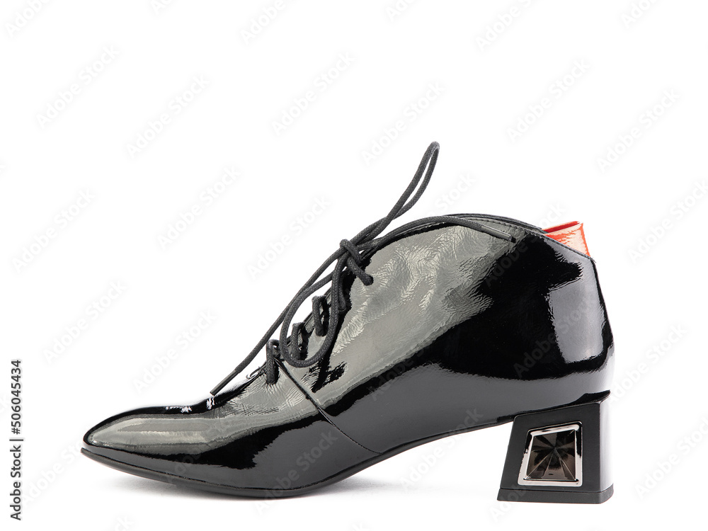 Women's autumn ankle black leather boots with black zip and average heels, isolated white background. Left side view. Fashion shoes.