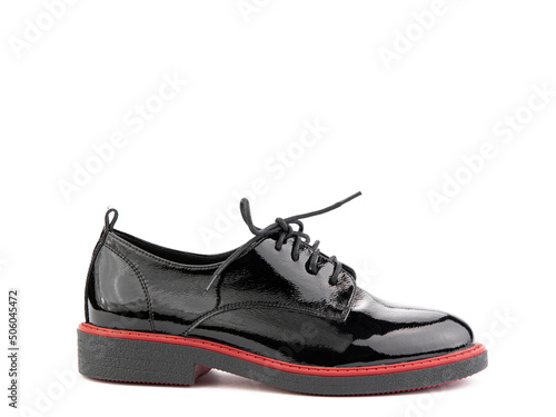 Obraz na płótnie Women's oxford black leather shoes with red stripe isolated white background. Right side view. Fashion shoes. Photoshoot for shoe shop concept. w salonie