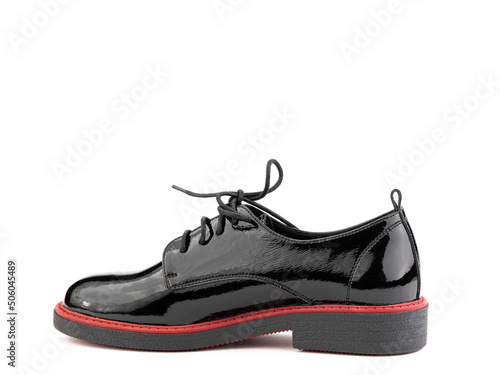 Women's oxford black leather shoes with red stripe isolated white background. Left side view. Fashion shoes. Photoshoot for shoe shop concept.