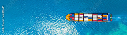 Aerial top view of cargo ship carrying container and running for export  goods  from  cargo yard port to custom ocean concept technology transportation , customs clearance.