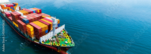 Aerial side view of cargo ship carrying container and running for export  goods  from  cargo yard port to custom ocean concept technology transportation , customs clearance. photo