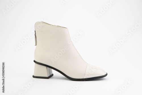 Women's autumn ankle white leather boots with zip and average heels, isolated white background. Right side view. Fashion shoes.