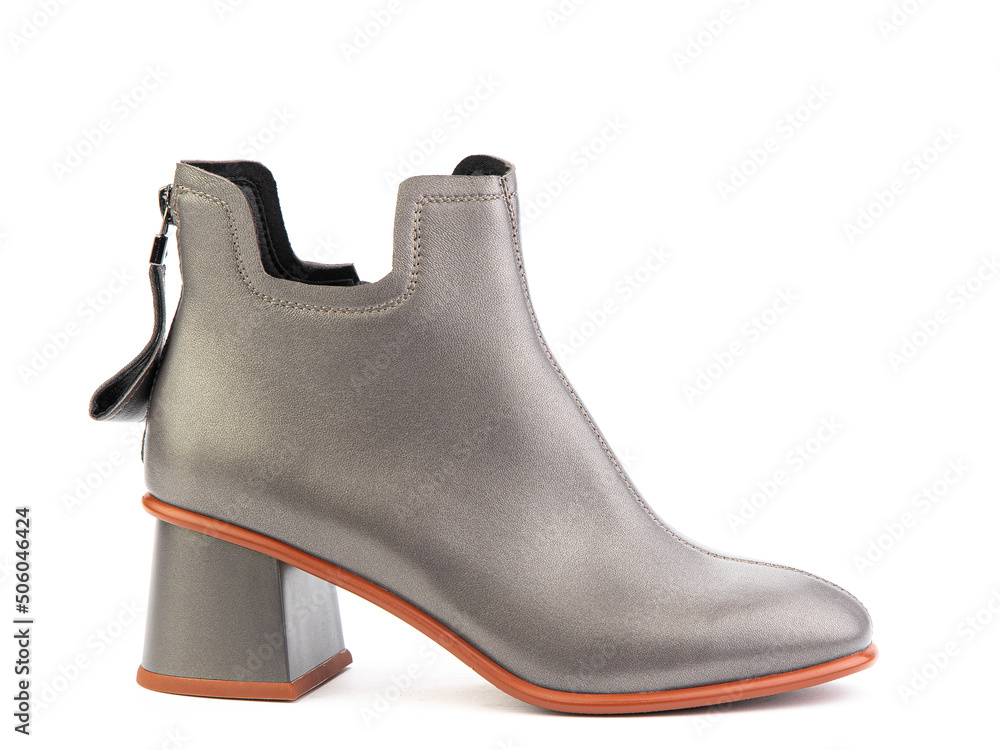 Women's autumn ankle grey leather boots with zip and average heels, isolated white background. Right side view. Fashion shoes.