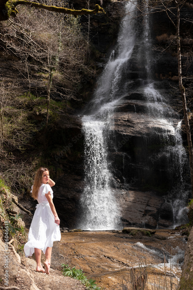 blonde woman in white dress at a waterfall Stock Photo | Adobe Stock