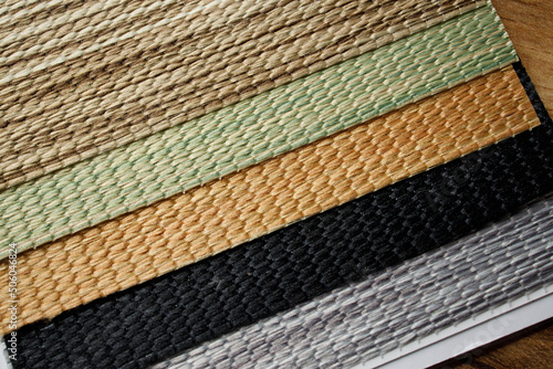 Samples of textured fabrics of different colors for the manufacture of fabric blinds for sun protection. Palette to choose from © volody10