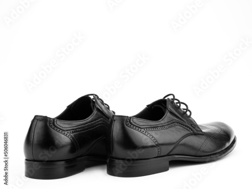 Obraz na płótnie A pair of classic leather elegant men's shoes isolated white background. Groom's stylish black shoes. Isolated object close up on white background. w salonie