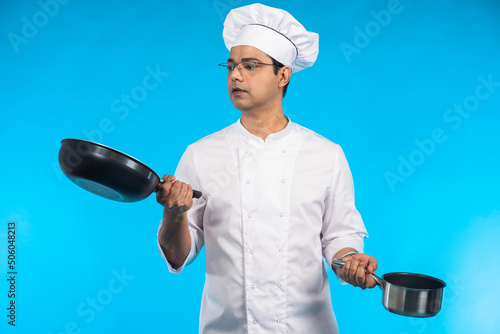 Cook with pots. Guy in chef...
