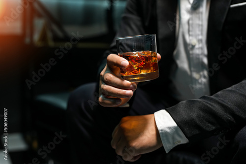 Closeup businessmen holding a glass of whiskey