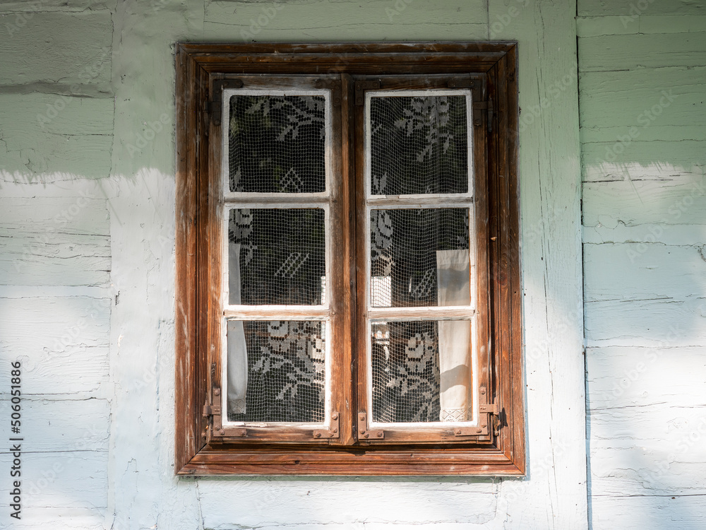A window in a white wooden hut, Traditional wooden hut, Wooden traditional window, Poland A window in a white wooden hut, Traditional wooden hut, Wooden traditional window, Poland