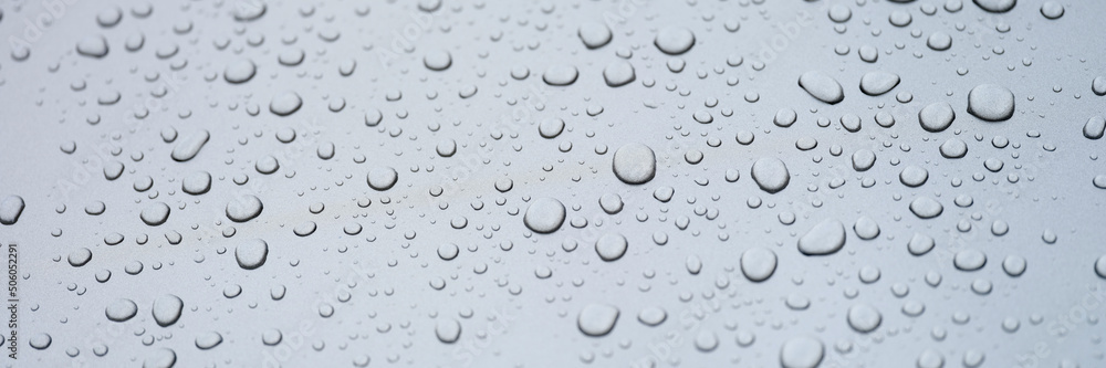 Water drops on glass, gray background, close-up Water drops on glass, gray background, close-up