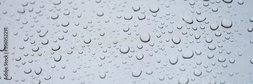 Water drops on glass  gray background  close-up